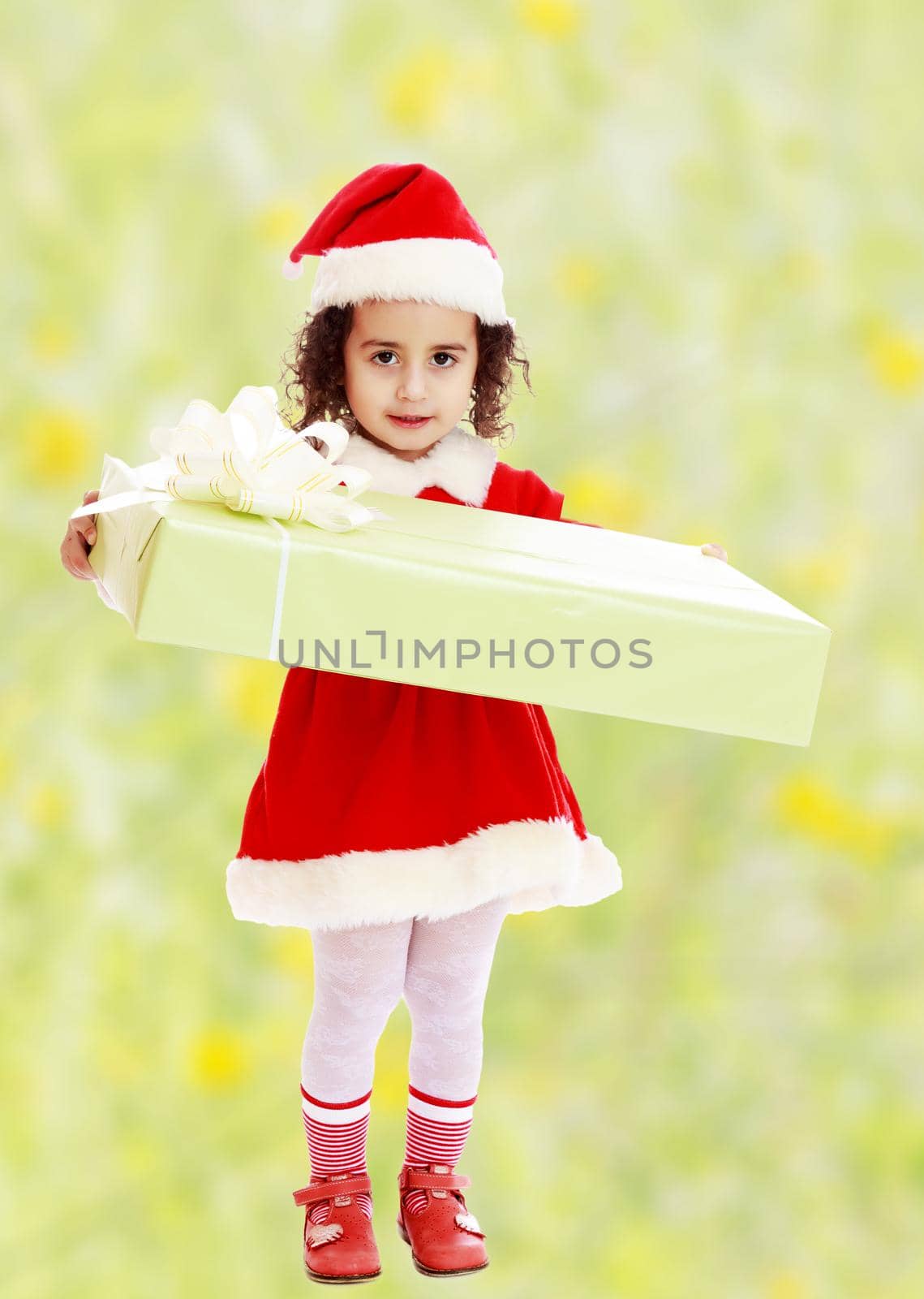 Little girl in costume of Santa Claus with gift by kolesnikov_studio