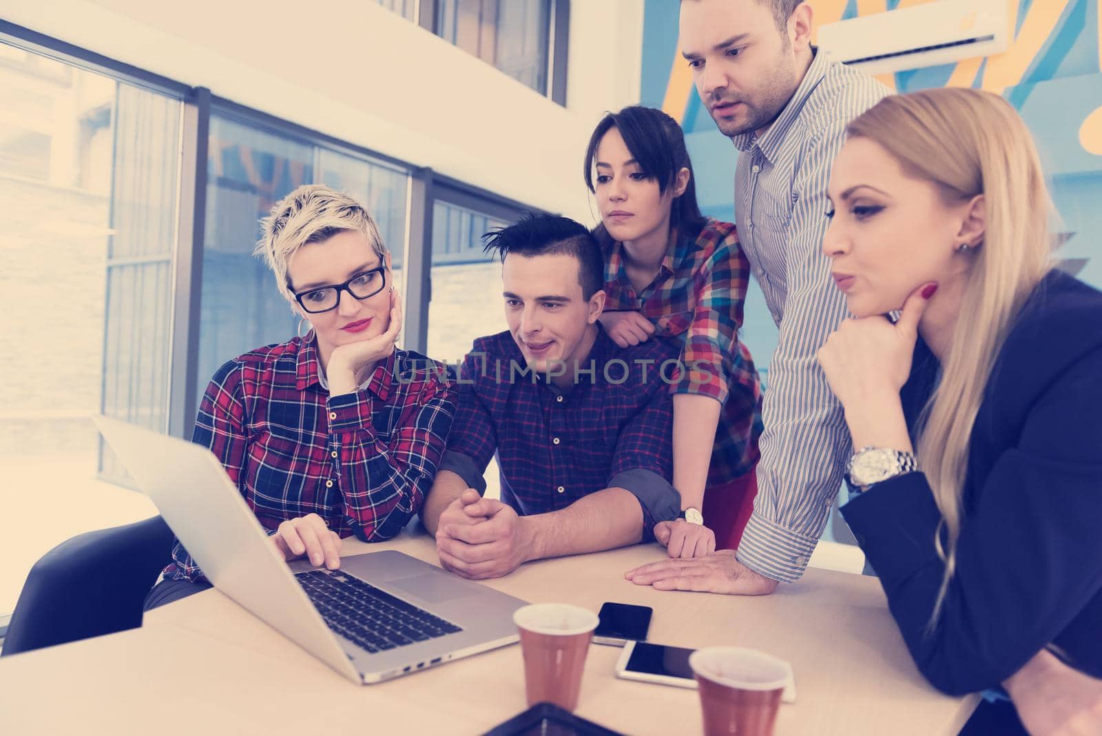 startup business team on meeting in modern bright office interior brainstorming, working on laptop and tablet computer