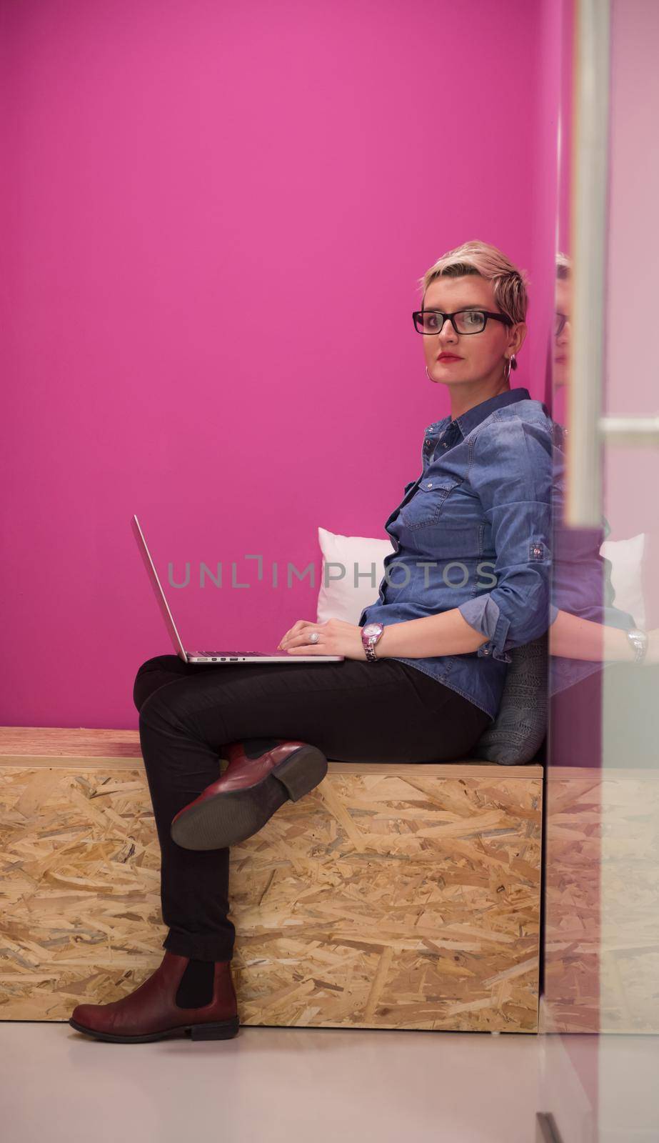 young woman in crative box working on laptop computer, startup business modern office room  interior