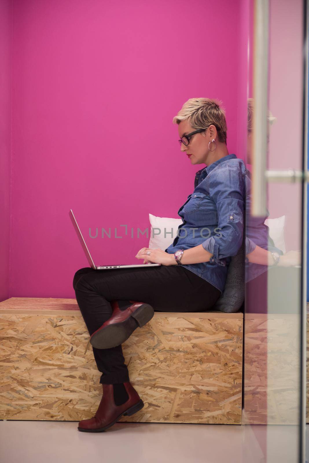 young woman in crative box working on laptop computer, startup business modern office room  interior