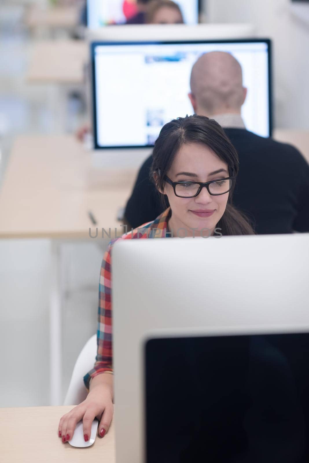 startup business, woman  working on dektop  computer at creative modern office relaxing and have fun