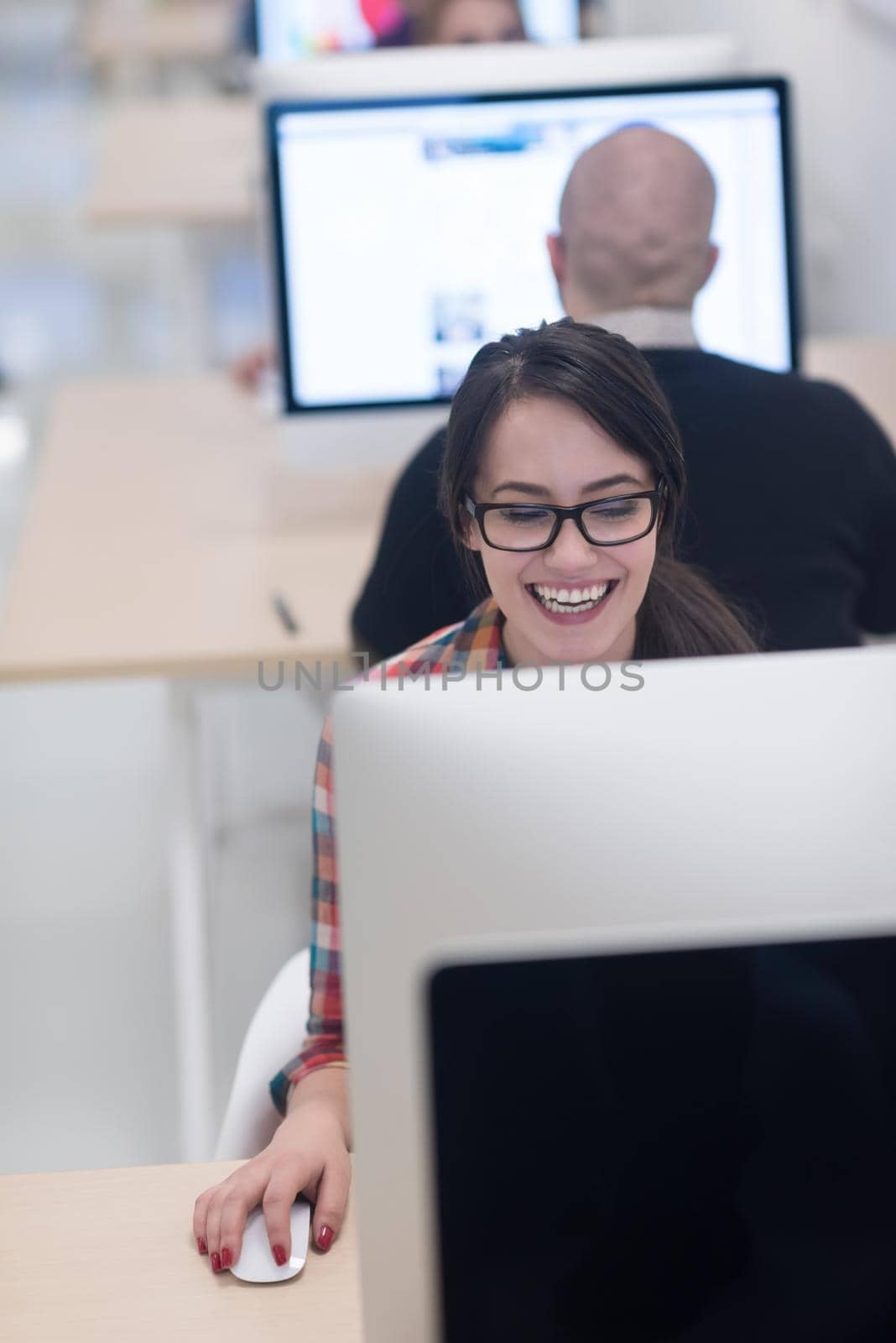 startup business, woman  working on dektop  computer at creative modern office relaxing and have fun