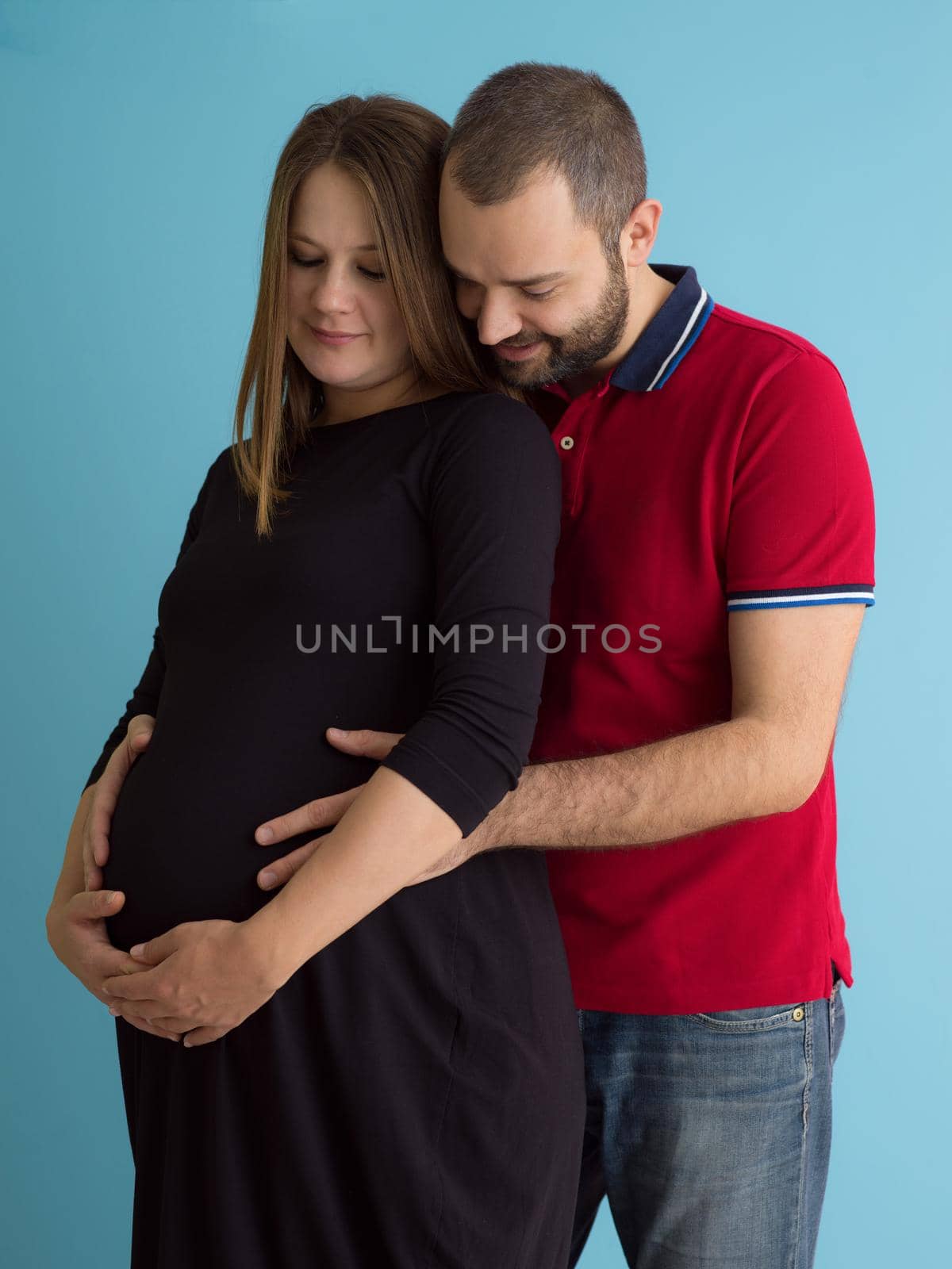 pregnant couple  isolated over blue background by dotshock