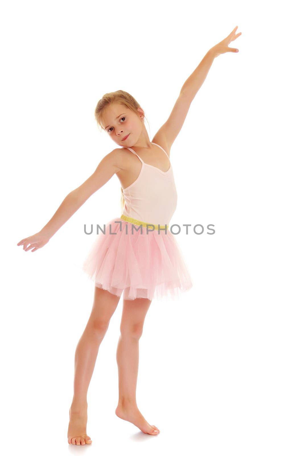 Charming little girl ballerina in a pink translucent dress.Isolated on white.