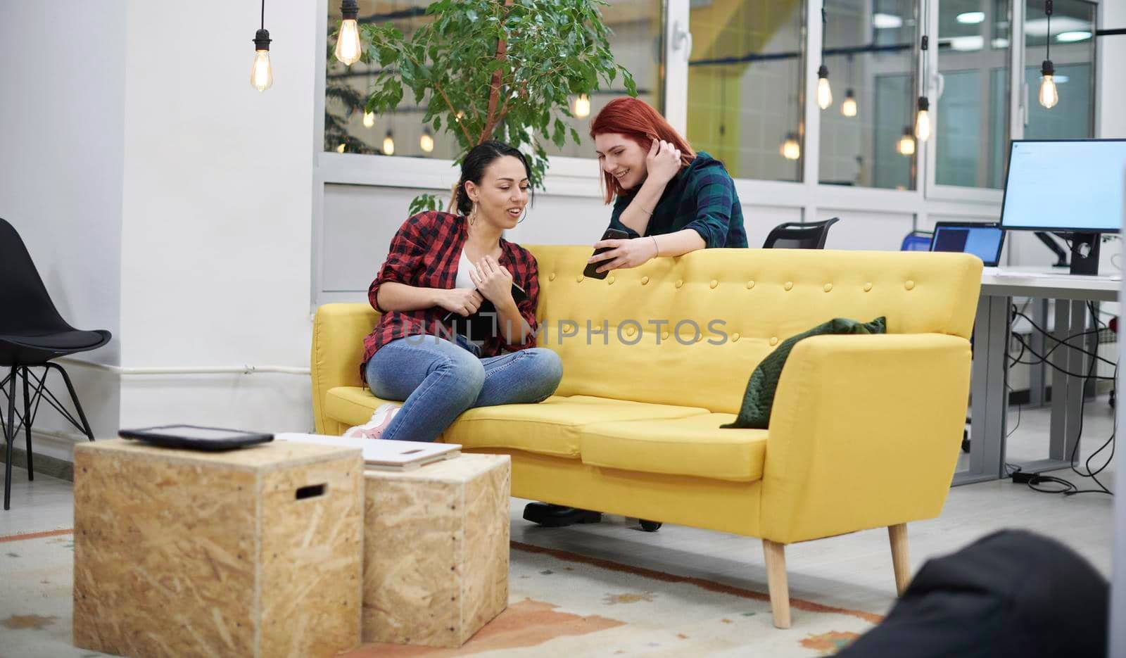 group of female friends having a team meeting and discussion about project or gossip chatting in modern startup business office