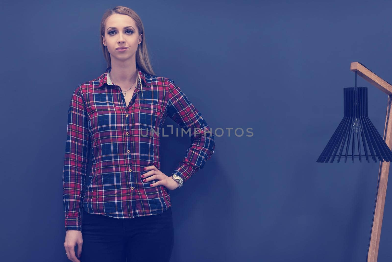 portrait of young startup business woman at modern office, grey chalkboard wall in background