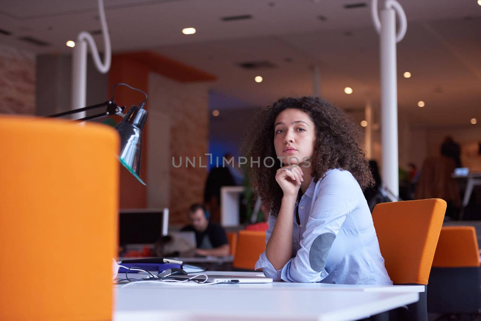 happy young  business woman with curly hairstyle in the modern office