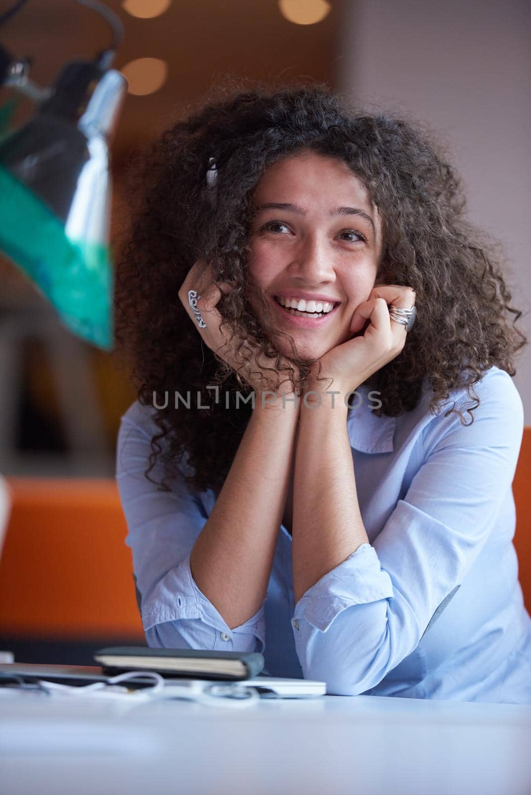 happy young  business woman with curly hairstyle in the modern office