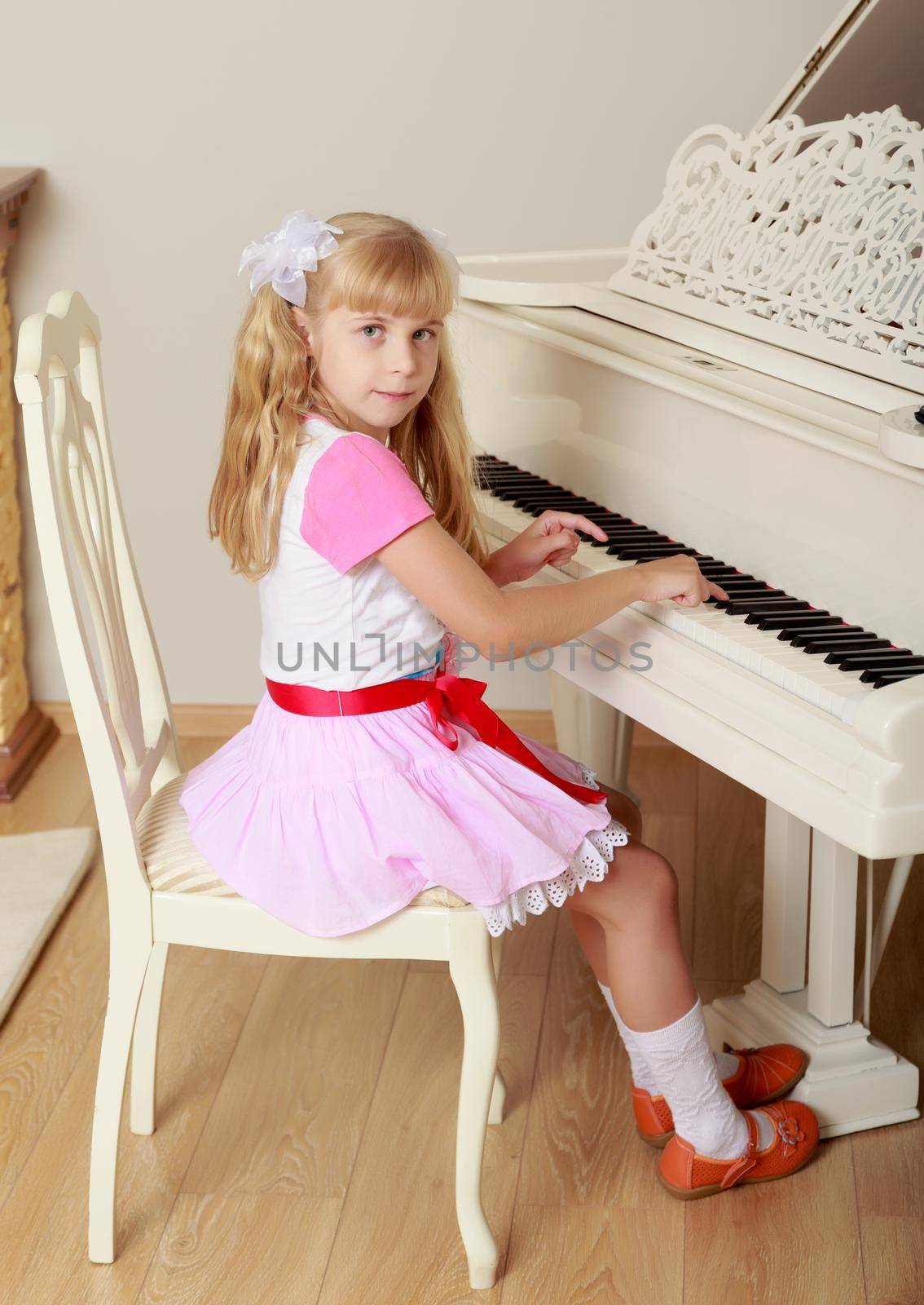 Girl playing the piano by kolesnikov_studio