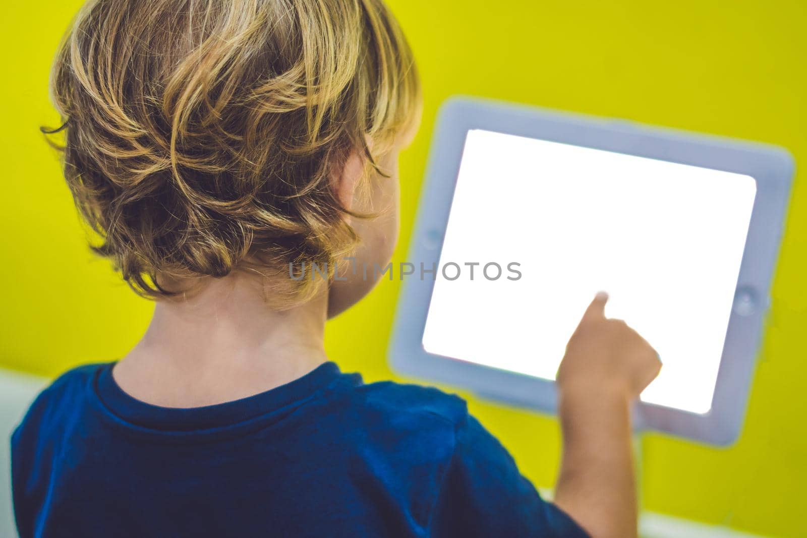 Boy playing with digital tablet. Children and technology concept by galitskaya