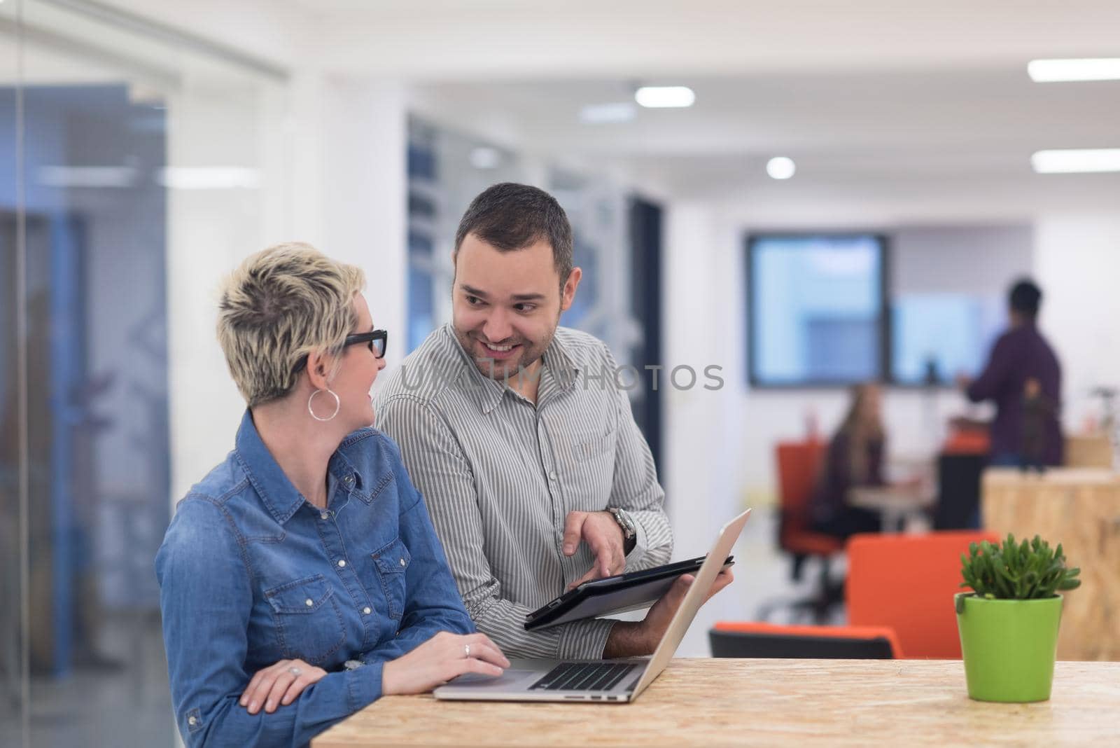 startup business team on meeting in modern bright office interior brainstorming, working on laptop and tablet computer