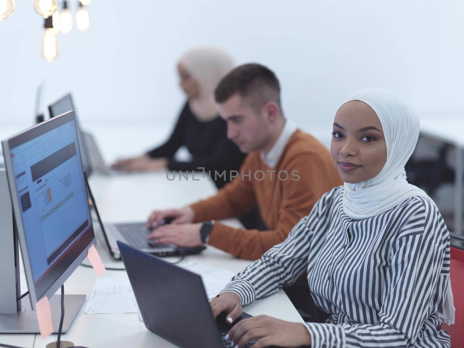 african black woman wearing hijab as part of creative business team creative freelancers in modern coworking open space startu office