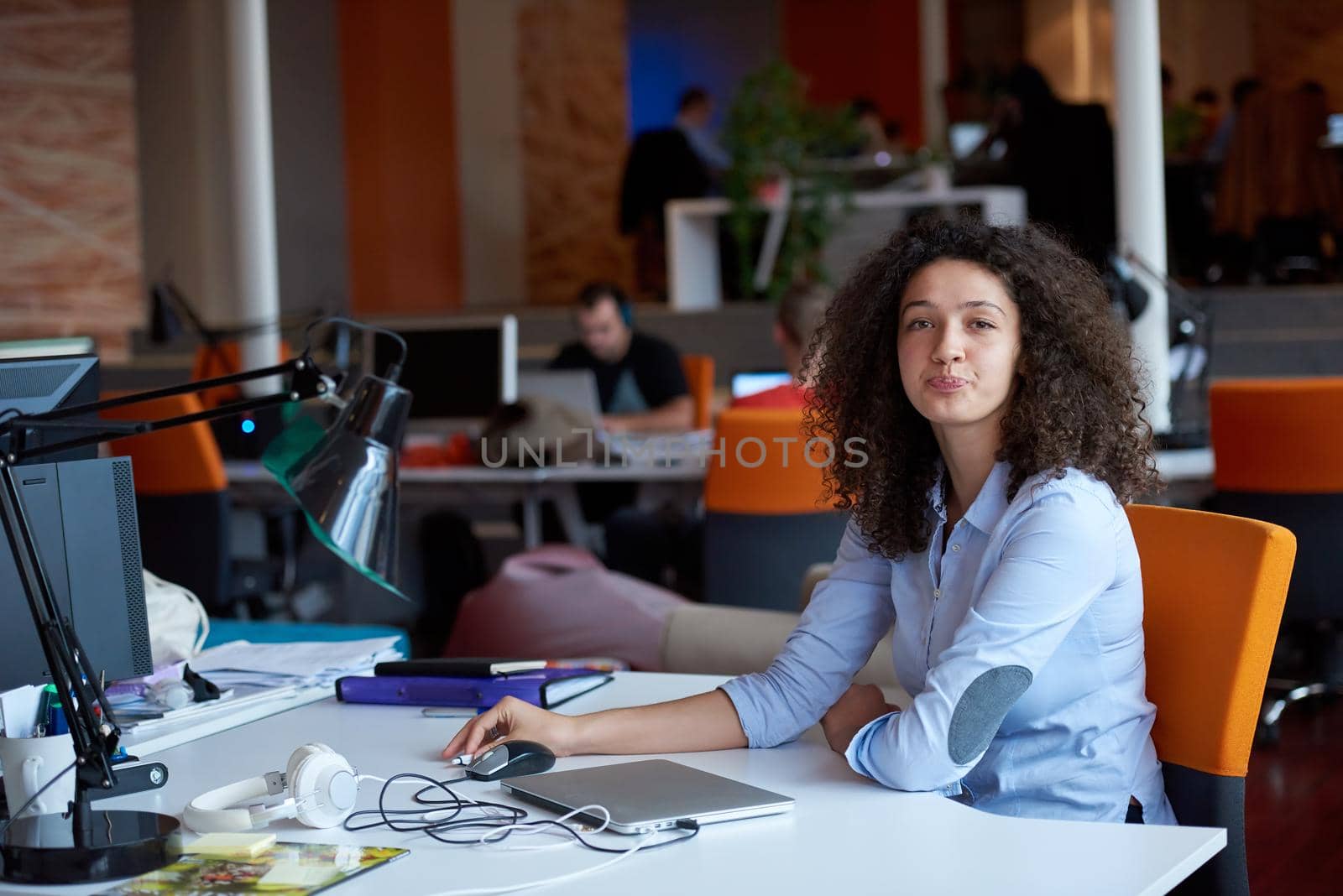 happy young  business woman with curly hairstyle in the modern office