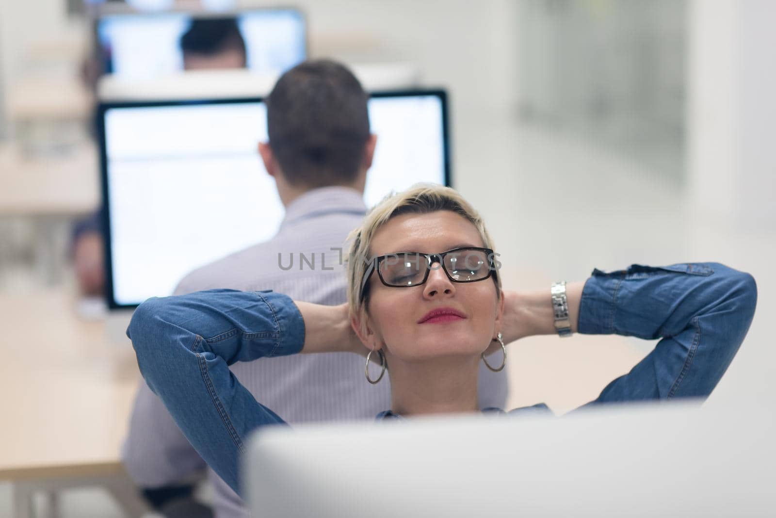 startup business, woman  working on dektop  computer at creative modern office relaxing and have fun