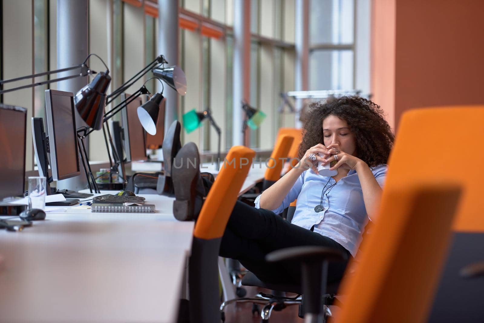 happy young  business woman with curly hairstyle in the modern office