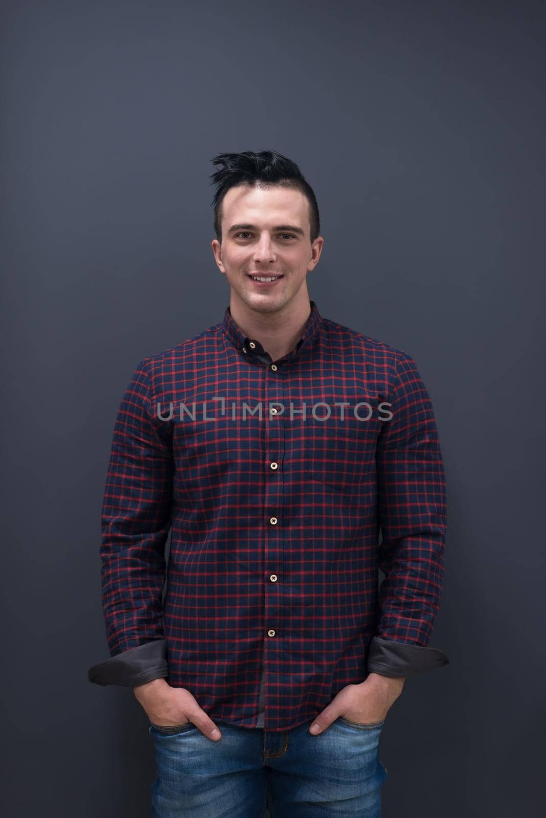 portrait of young business man in casual clothes grey wall in background