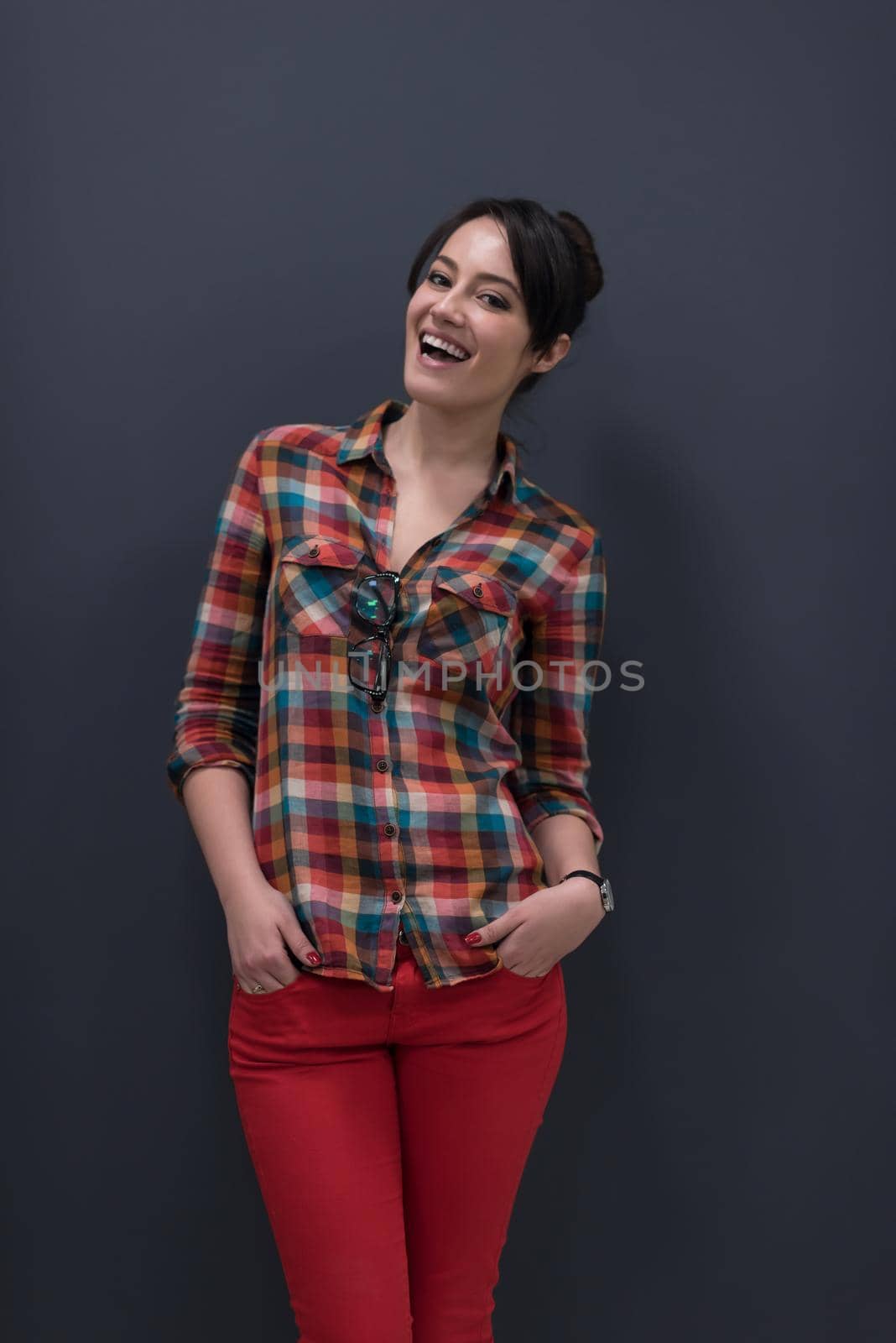 portrait of young startup business woman at modern office, grey chalkboard wall in background