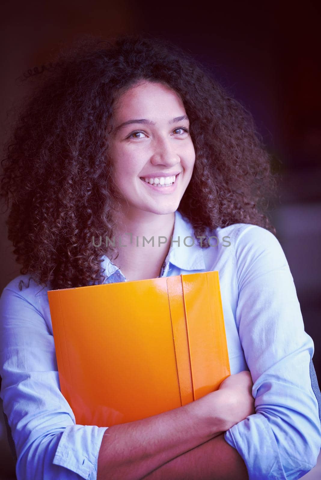 happy young  business woman with curly hairstyle in the modern office