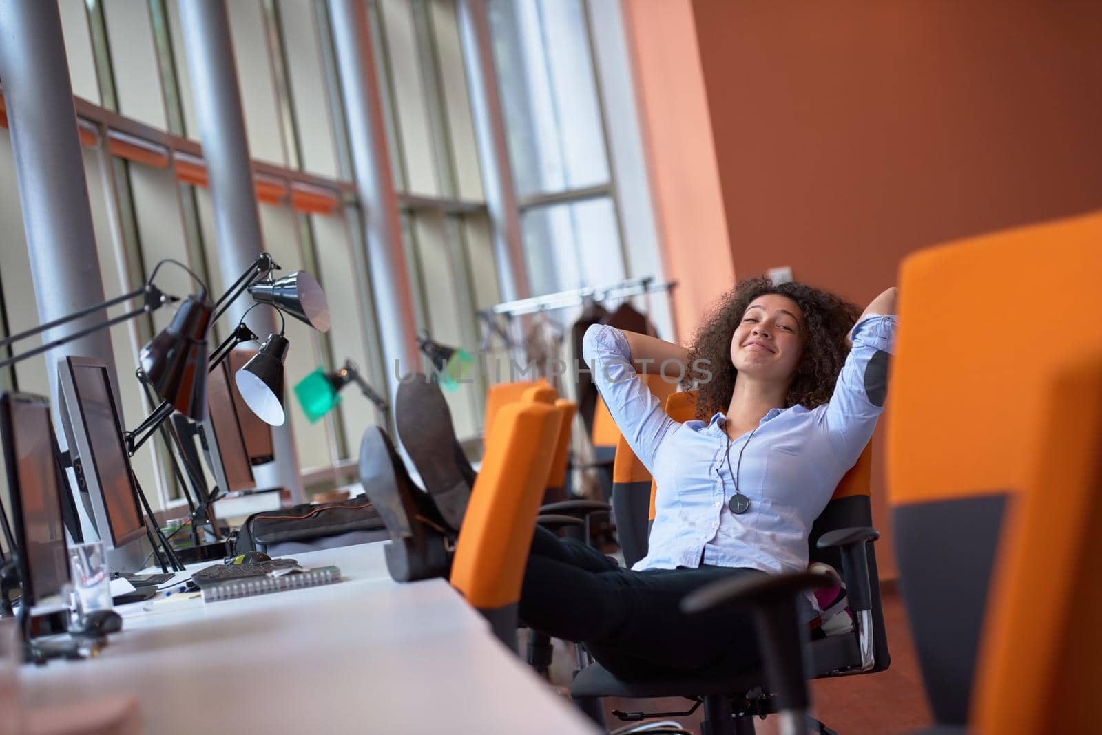 happy young  business woman with curly hairstyle in the modern office