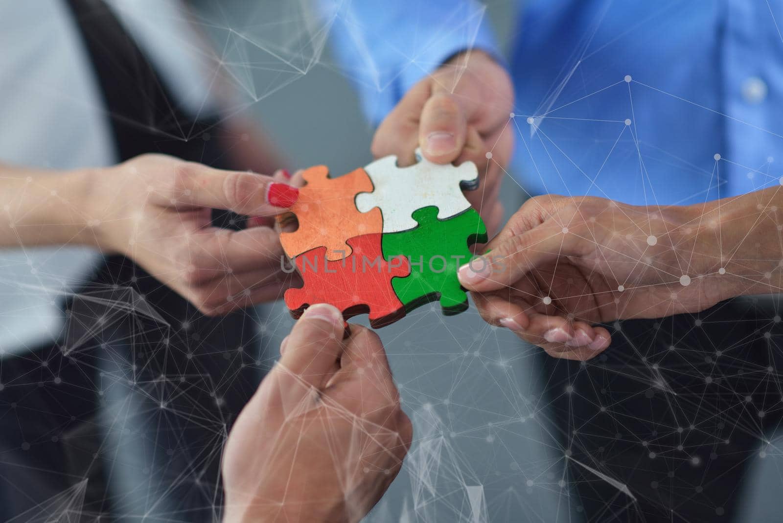 Group of business people assembling jigsaw puzzle by dotshock