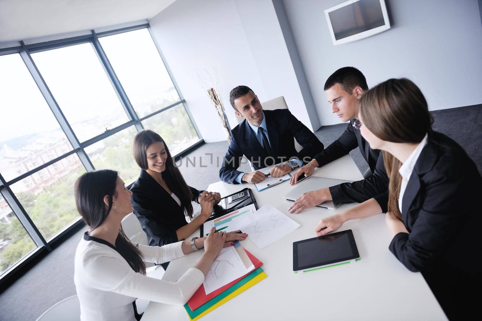 Group of happy young  business people in a meeting at office