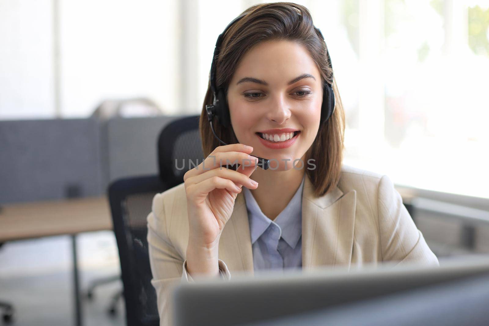 Woman customer support operator with headset and smiling. by tsyhun