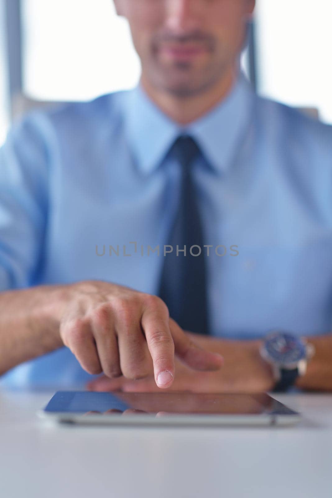 business man use tablet compuer at office by dotshock