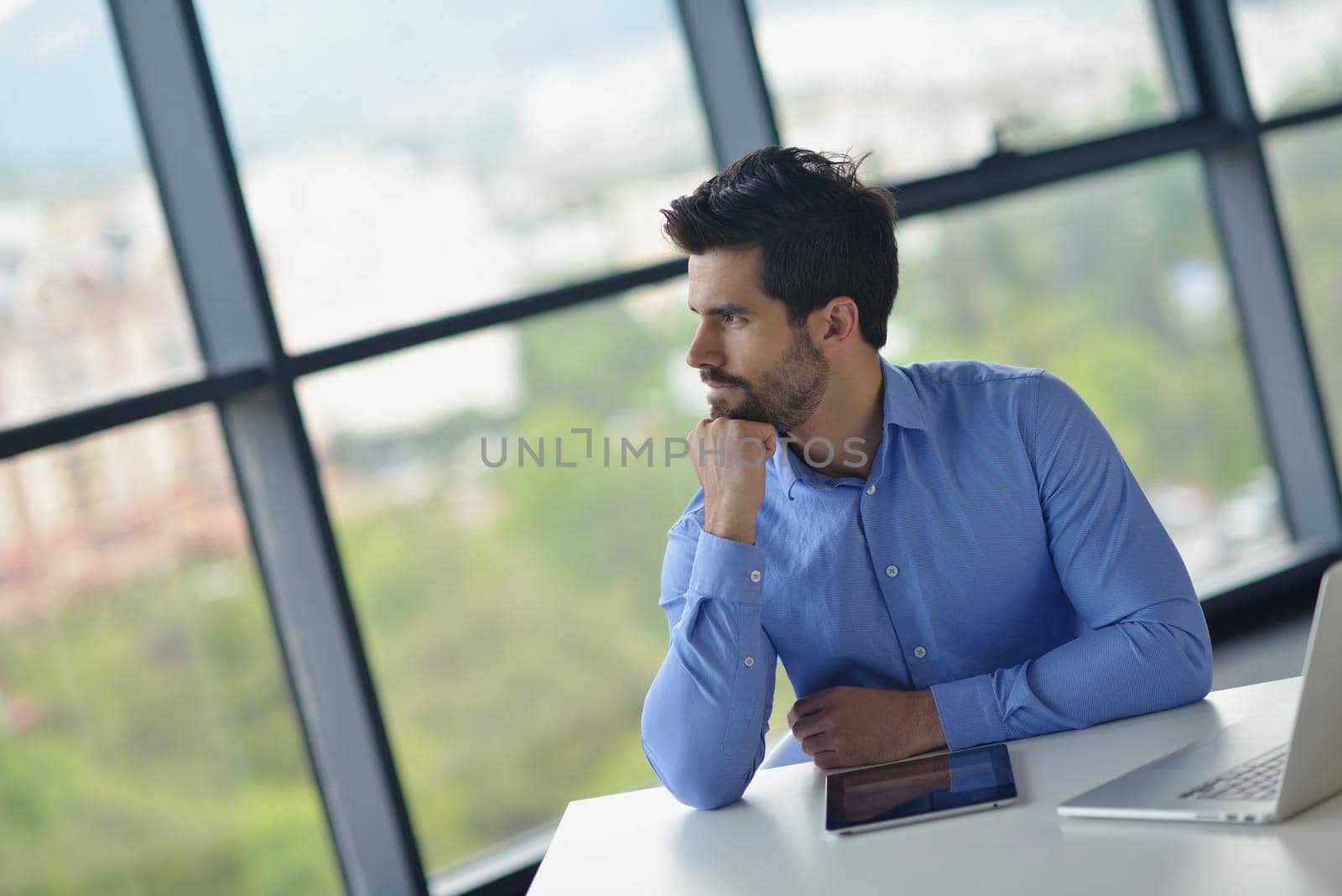 happy young business  man work in modern office on computer