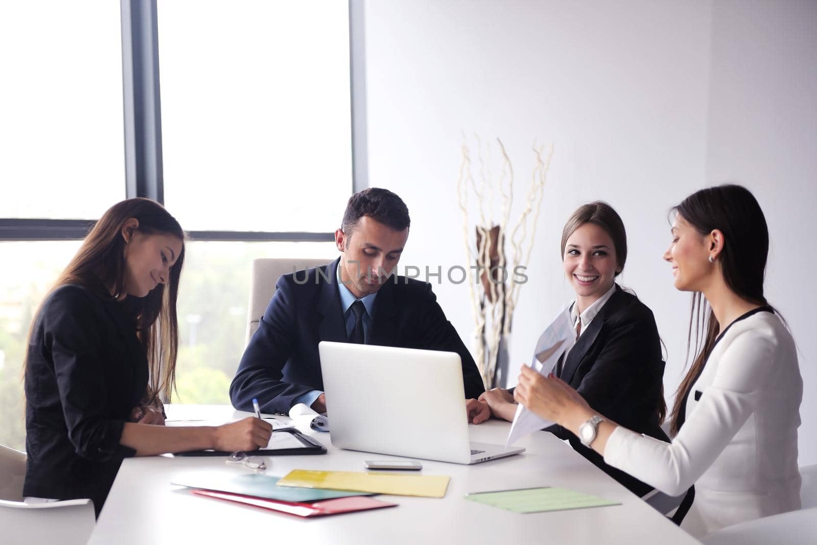 Group of happy young  business people in a meeting at office