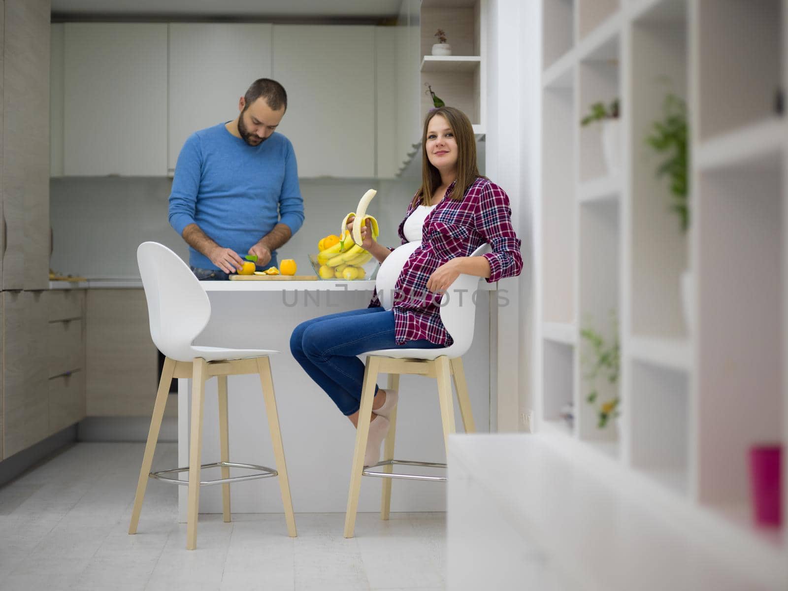 couple cooking food fruit lemon juice at kitchen by dotshock