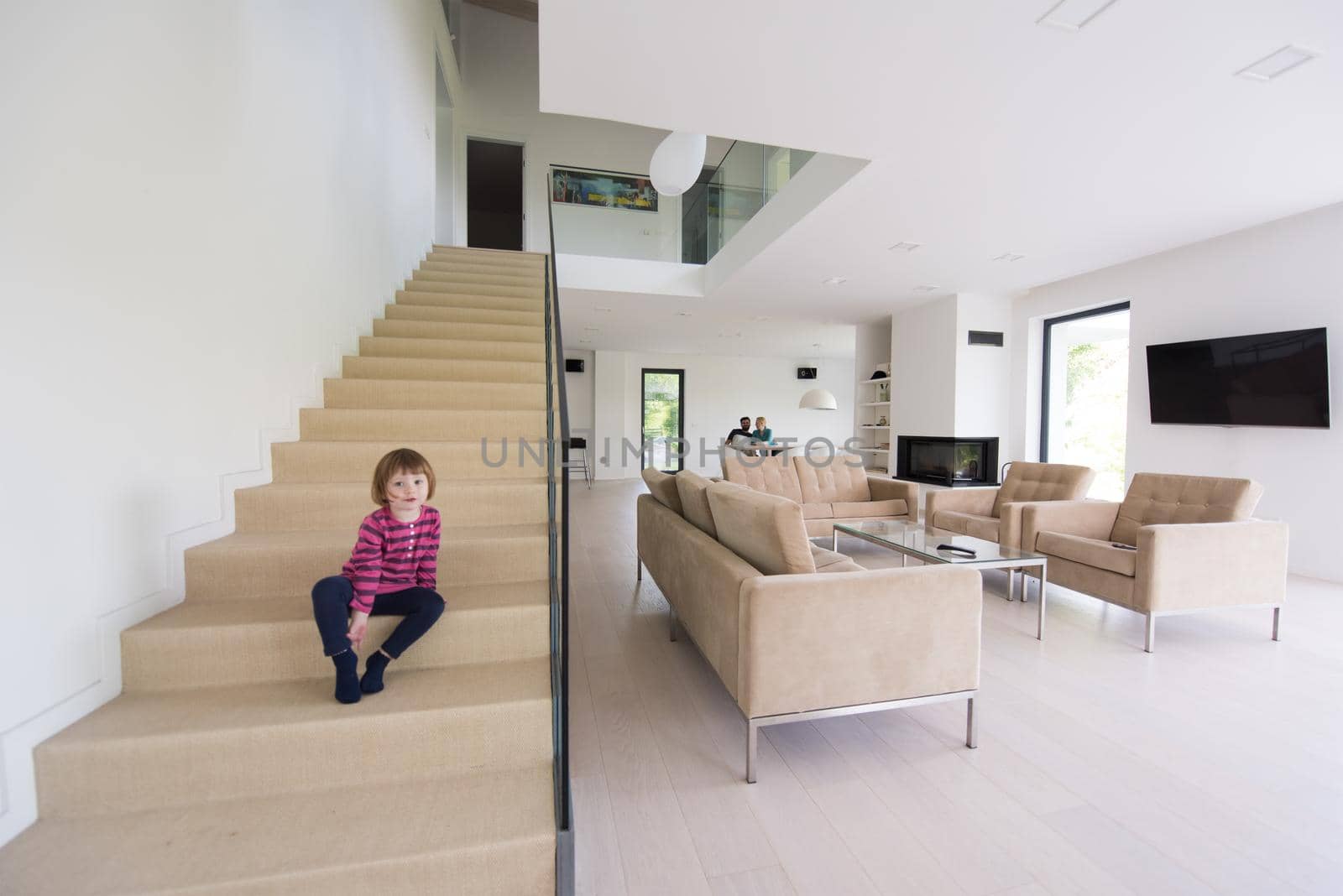 family with little girl enjoys in the modern living room by dotshock