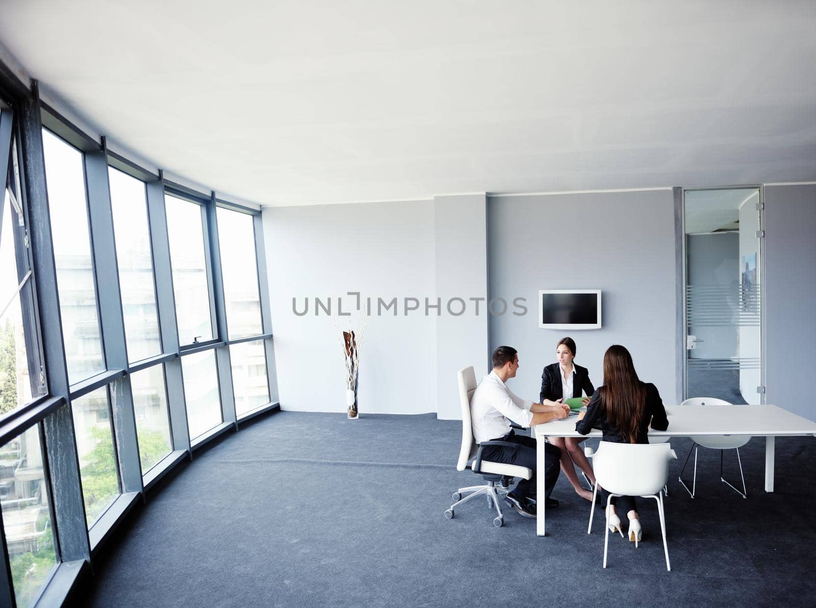 Group of happy young  business people in a meeting at office