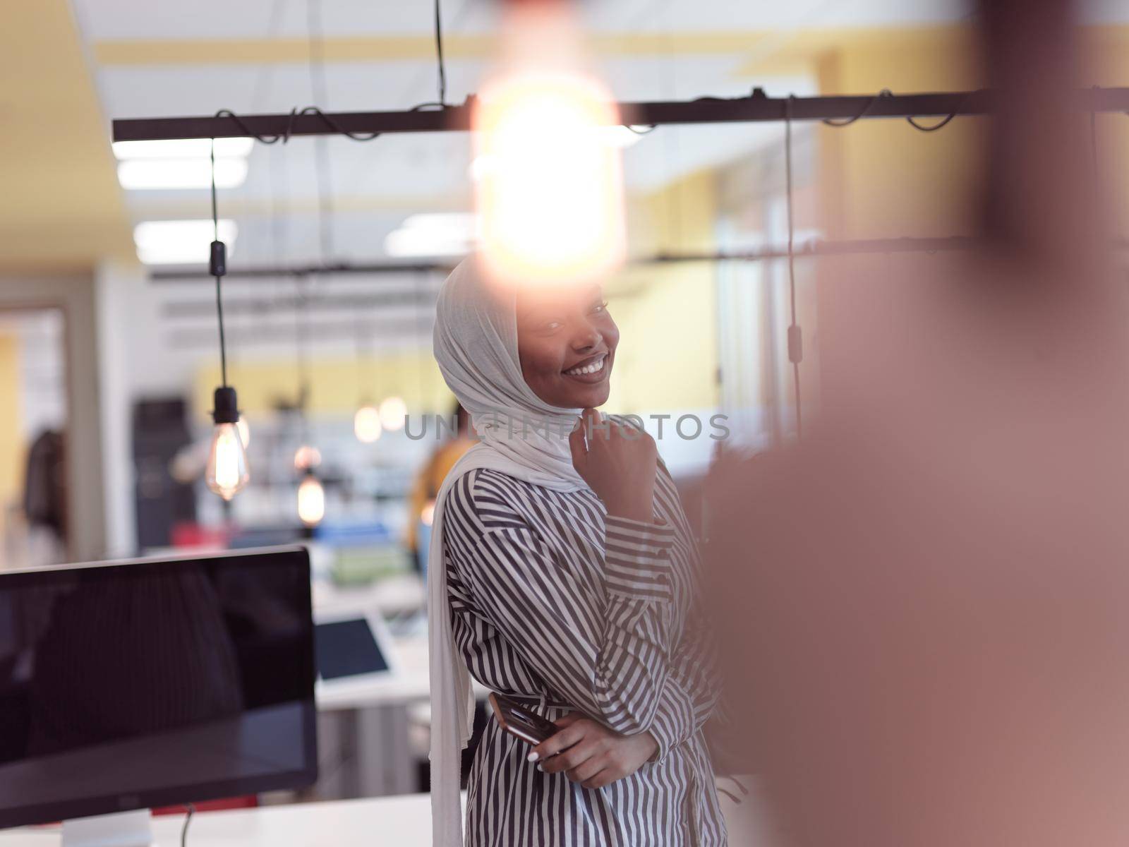 african americam modern muslim businesswoman portrait wearing hijab at creative modern startup coworking open space office