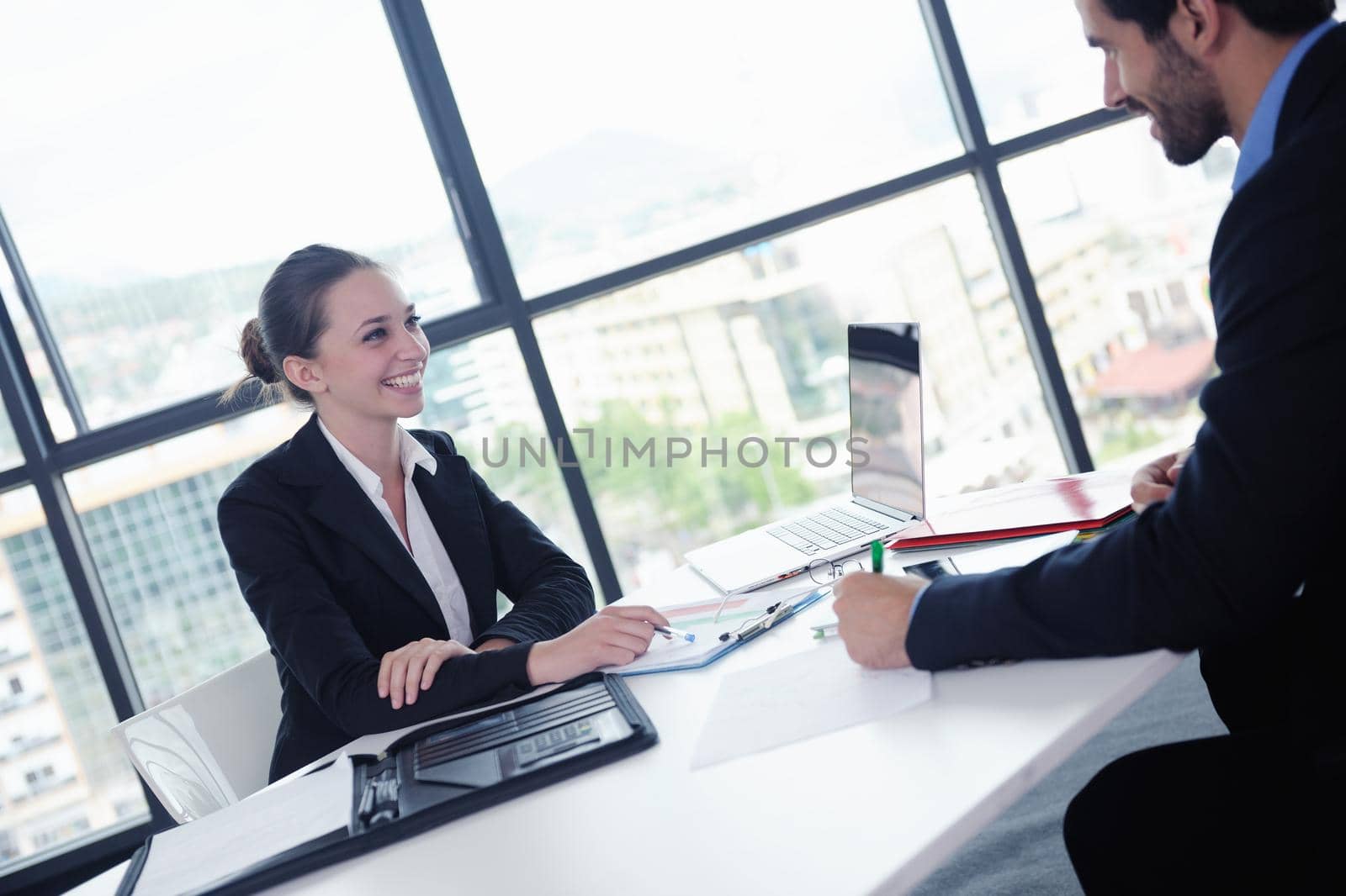 Group of happy young  business people in a meeting at office