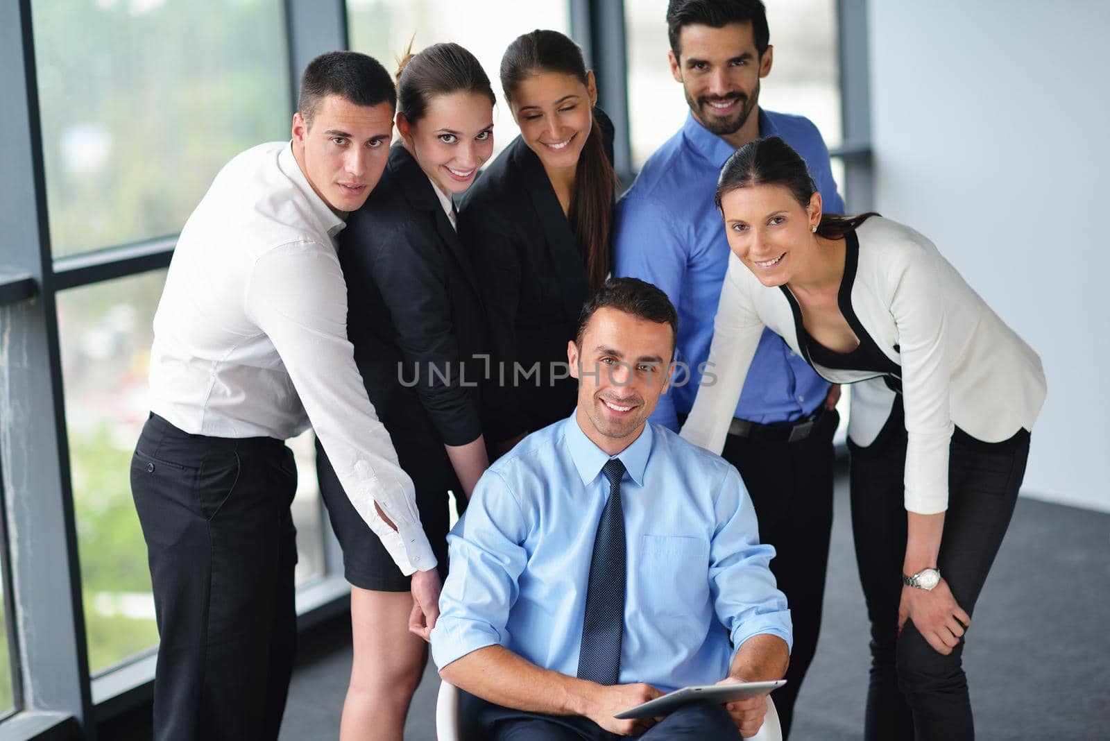 Group of happy young  business people in a meeting at office