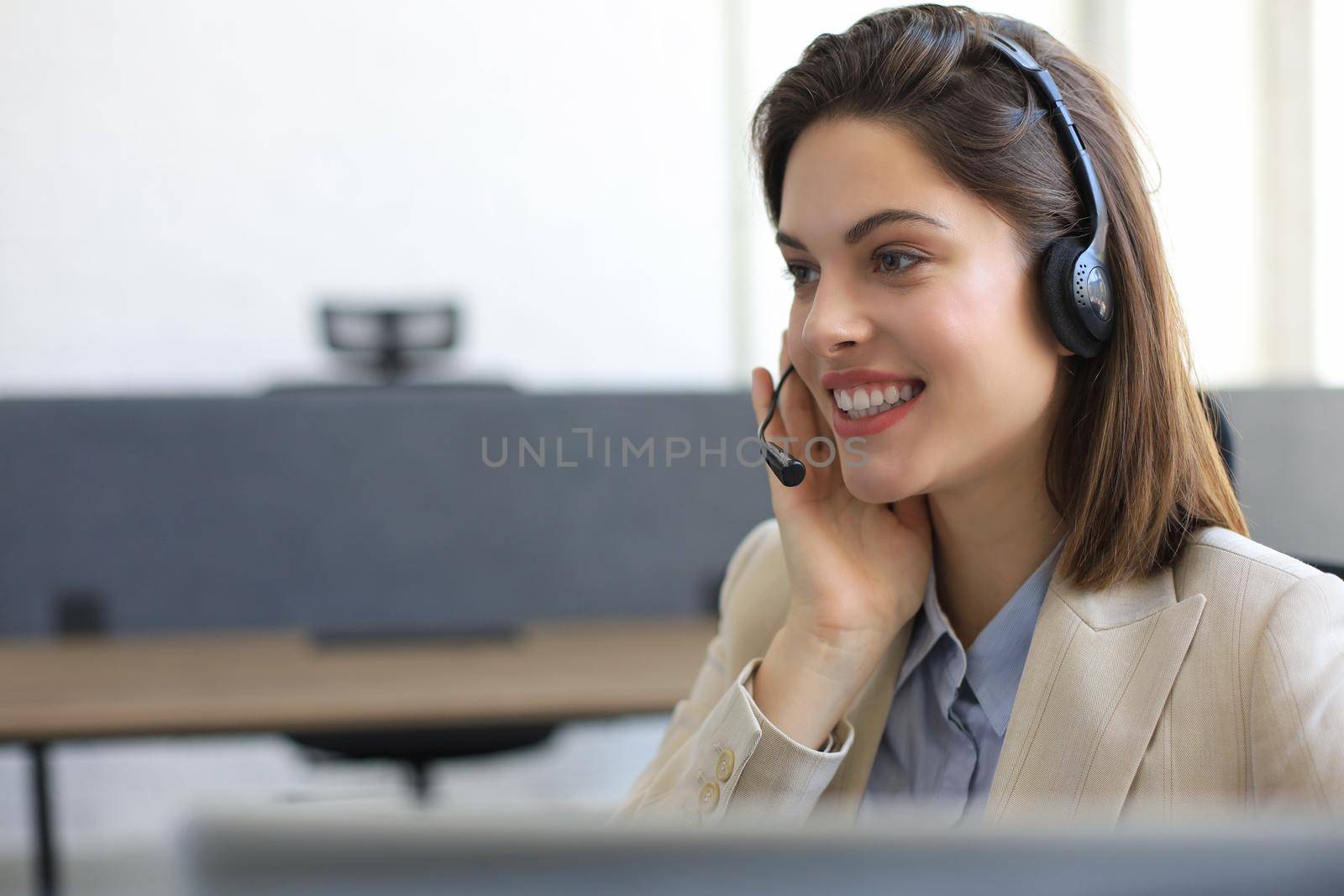 Woman customer support operator with headset and smiling. by tsyhun