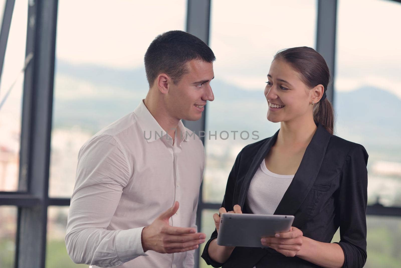 Group of happy young  business people in a meeting at office