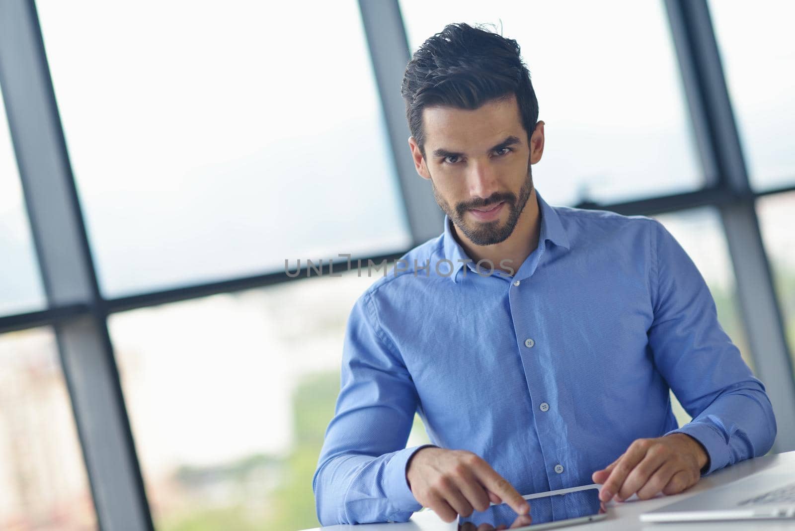 business man using tablet compuer at office by dotshock