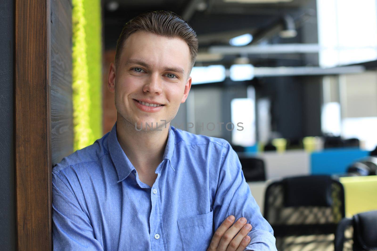 Young handsome businessman smiling in an office environment