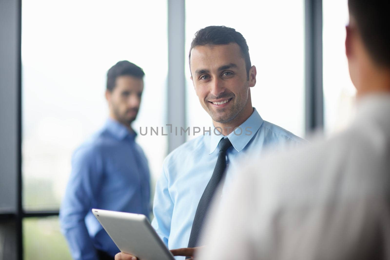 business man using tablet compuer at office by dotshock