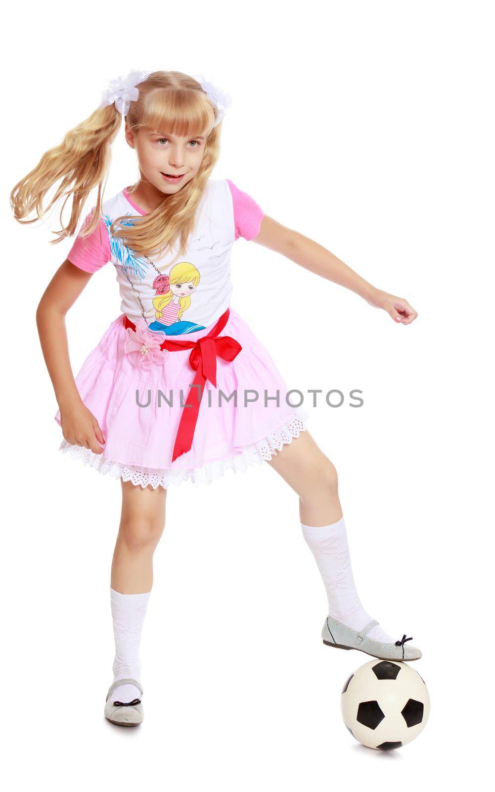 Enthusiastic little blonde girl in a short pink skirt, plays football-Isolated on white background