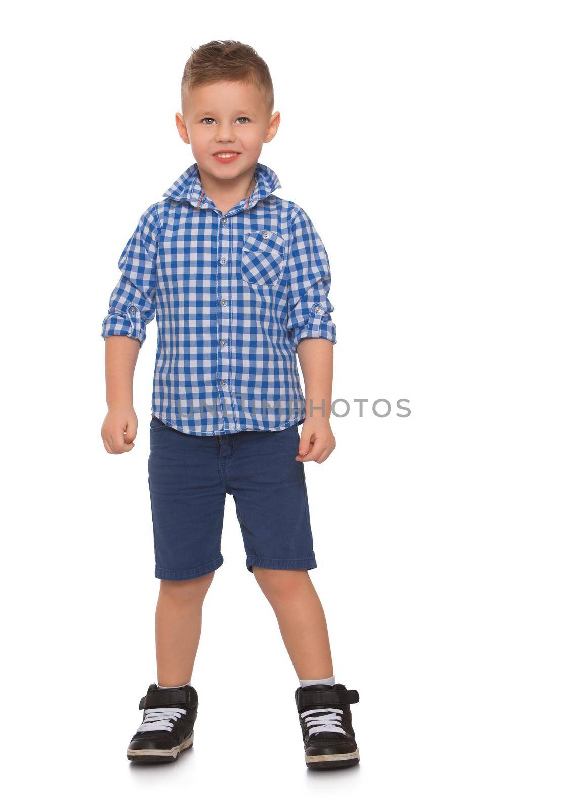 Nice little boy in shirt and shorts looking straight at the camera - Isolated on white background