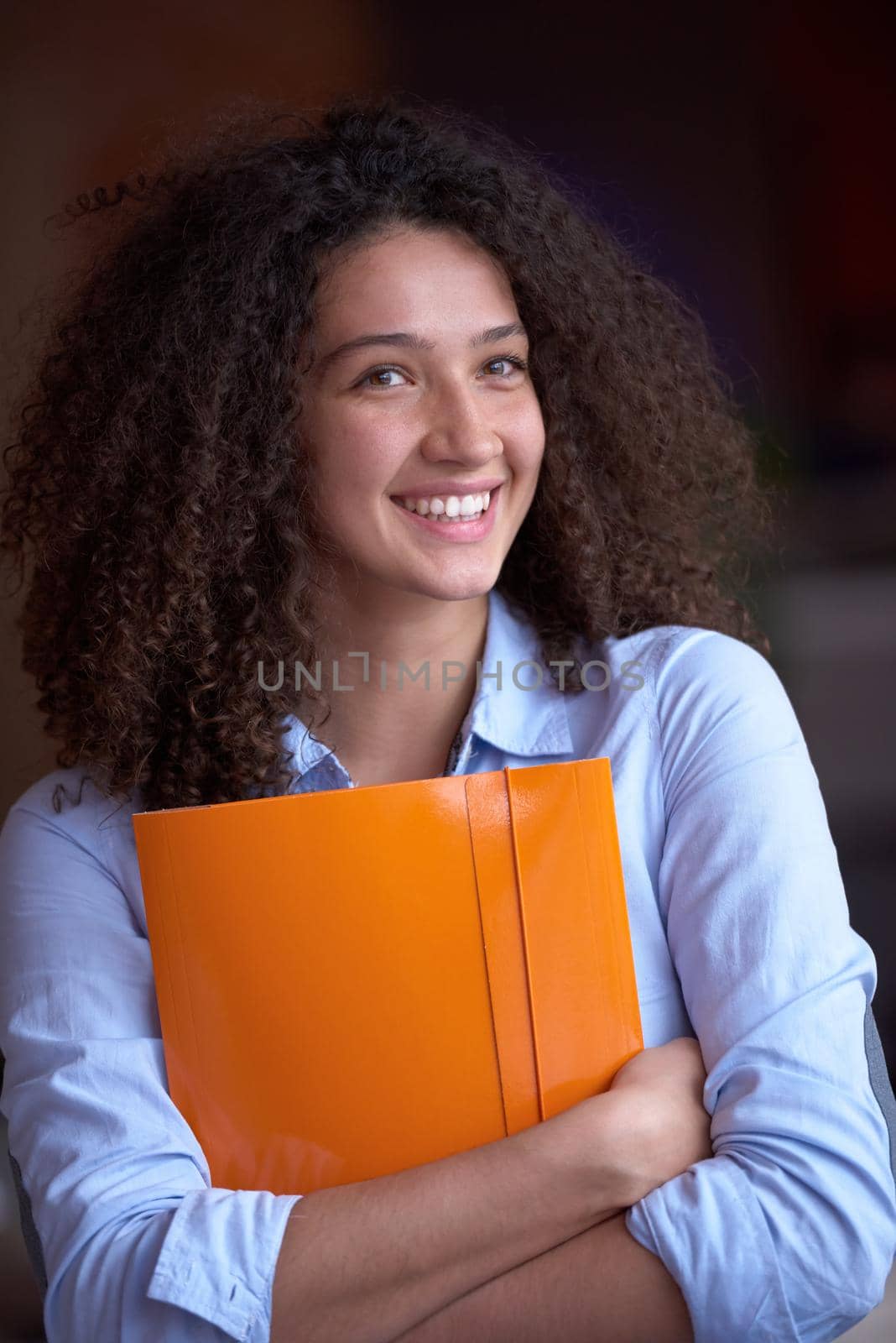 happy young  business woman with curly hairstyle in the modern office