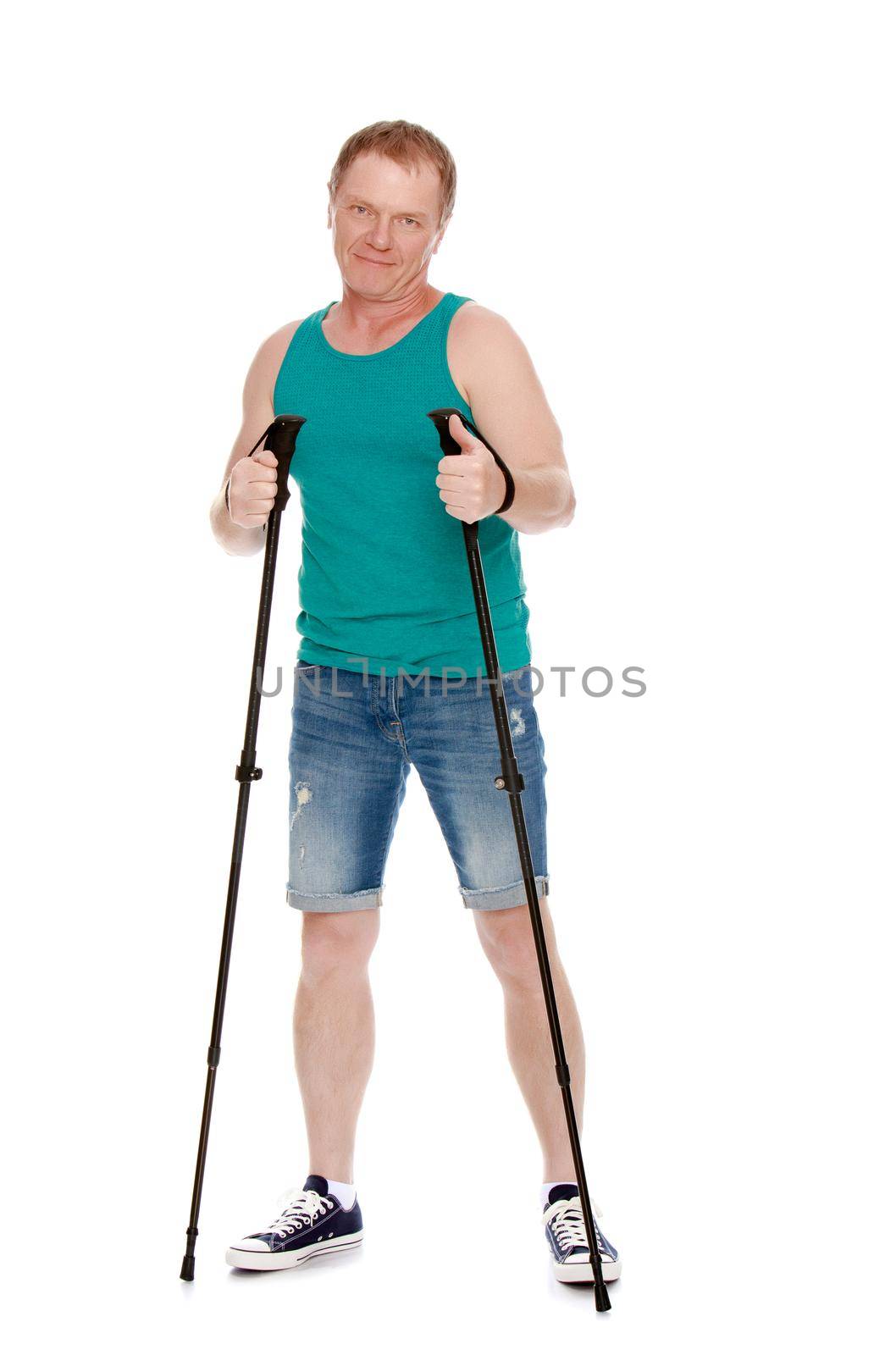 The concept of a healthy lifestyle and exercise.A 50 year old man involved in Nordic walking.Holds the sticks for Nordic walking.Isolated on white background