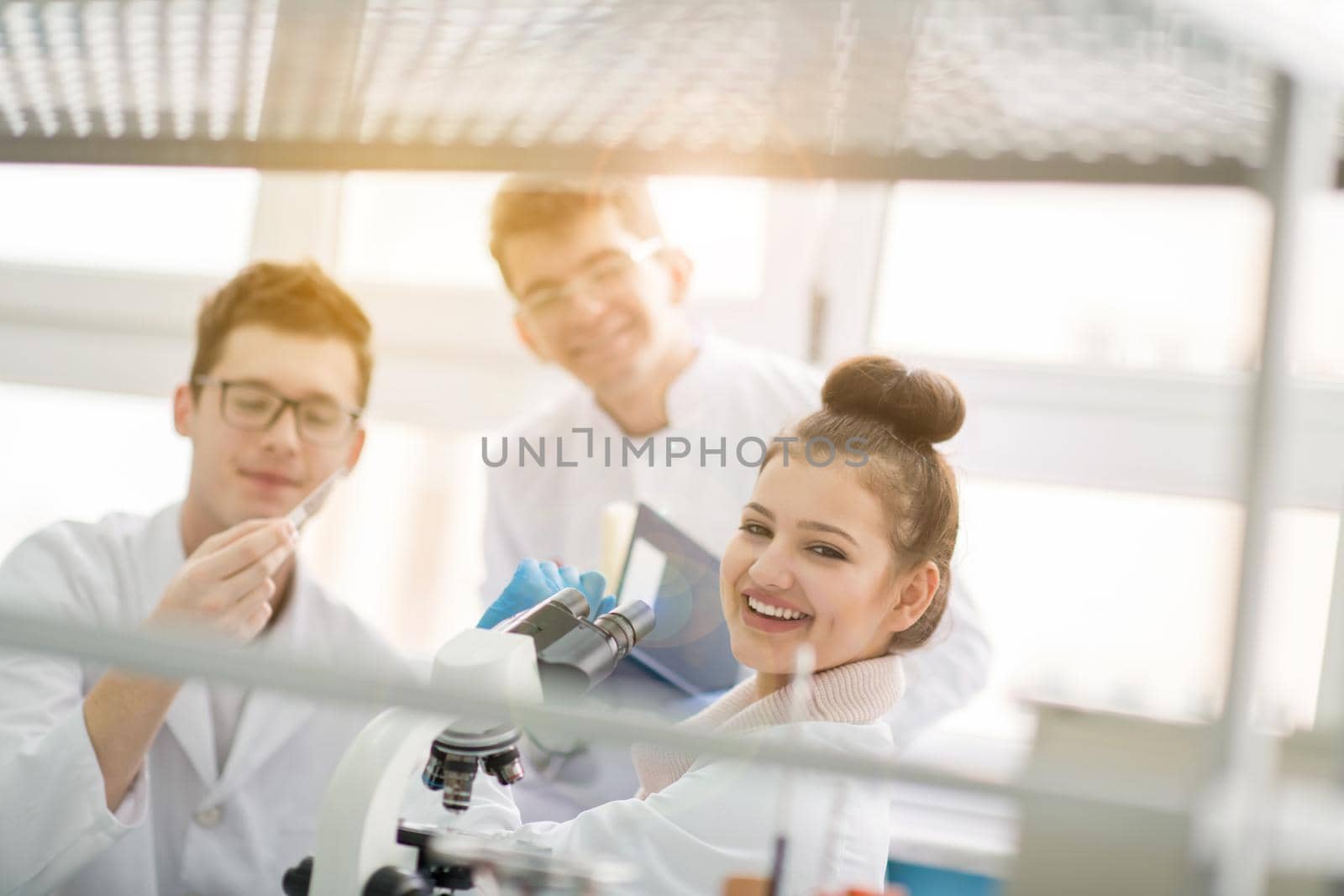 Group of young medical students doing research together in chemistry laboratory,teamwork by college student indoors