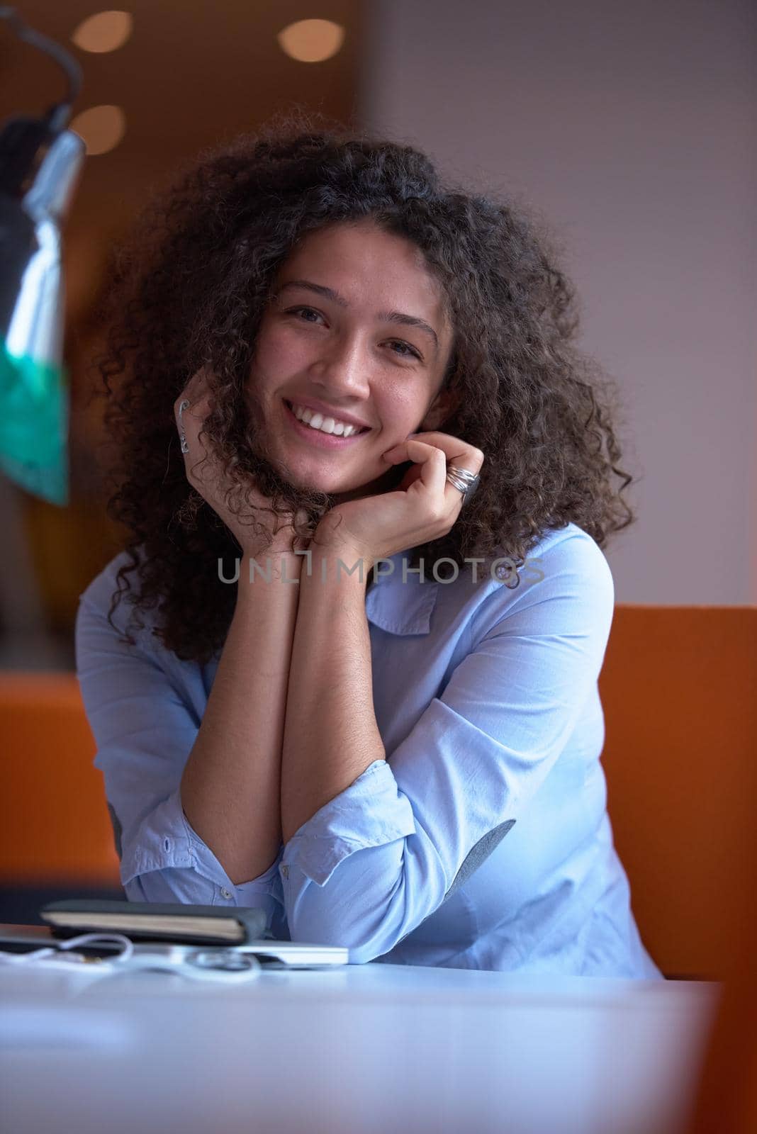 happy young  business woman with curly hairstyle in the modern office