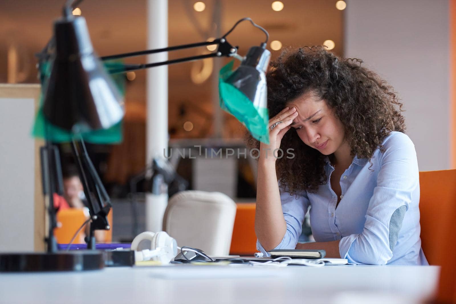 happy young  business woman with curly hairstyle in the modern office