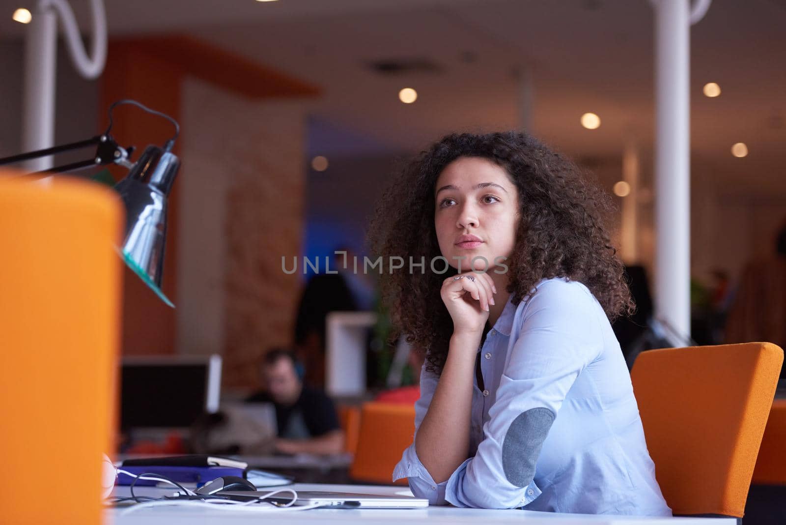 happy young  business woman with curly hairstyle in the modern office