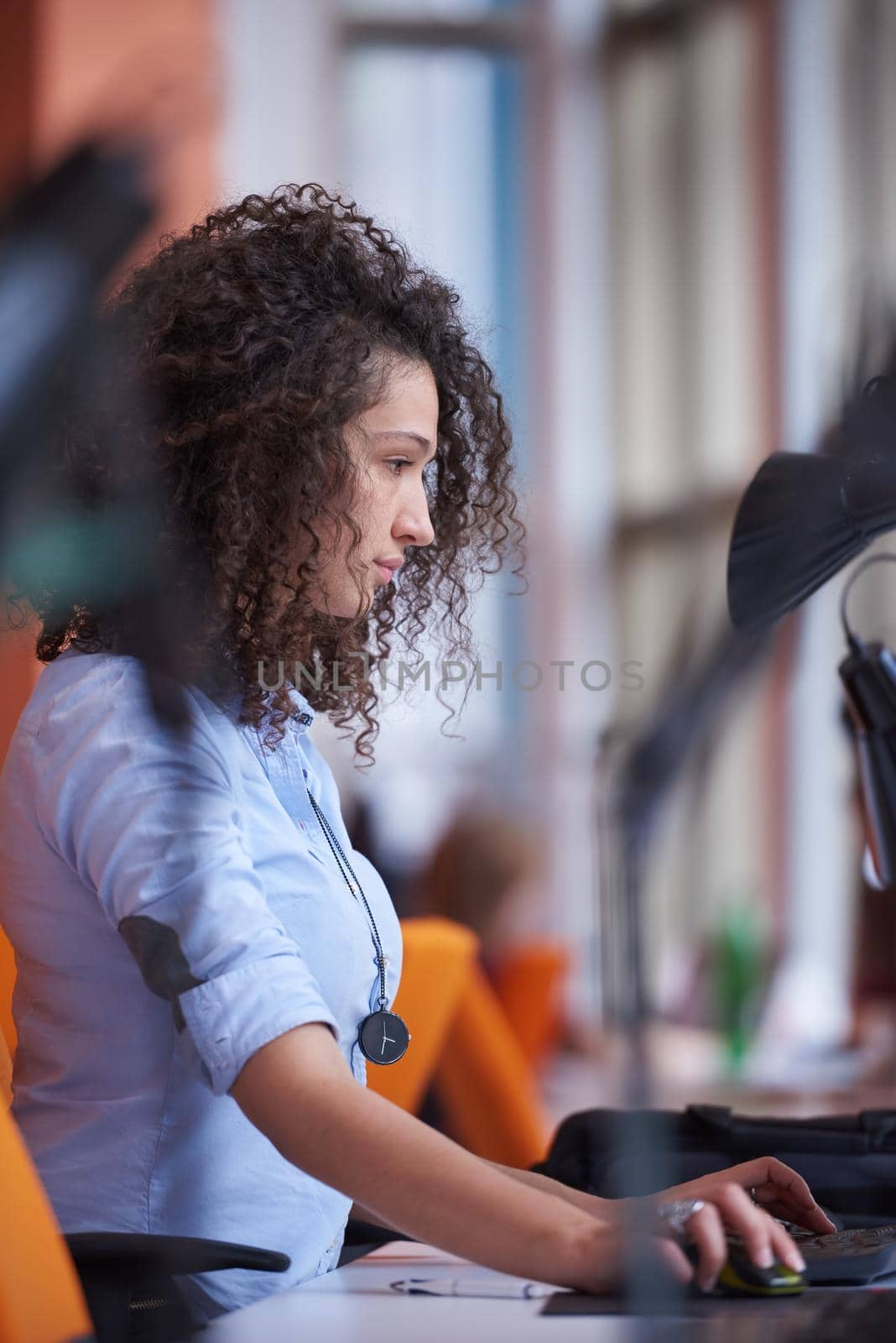 happy young  business woman with curly hairstyle in the modern office