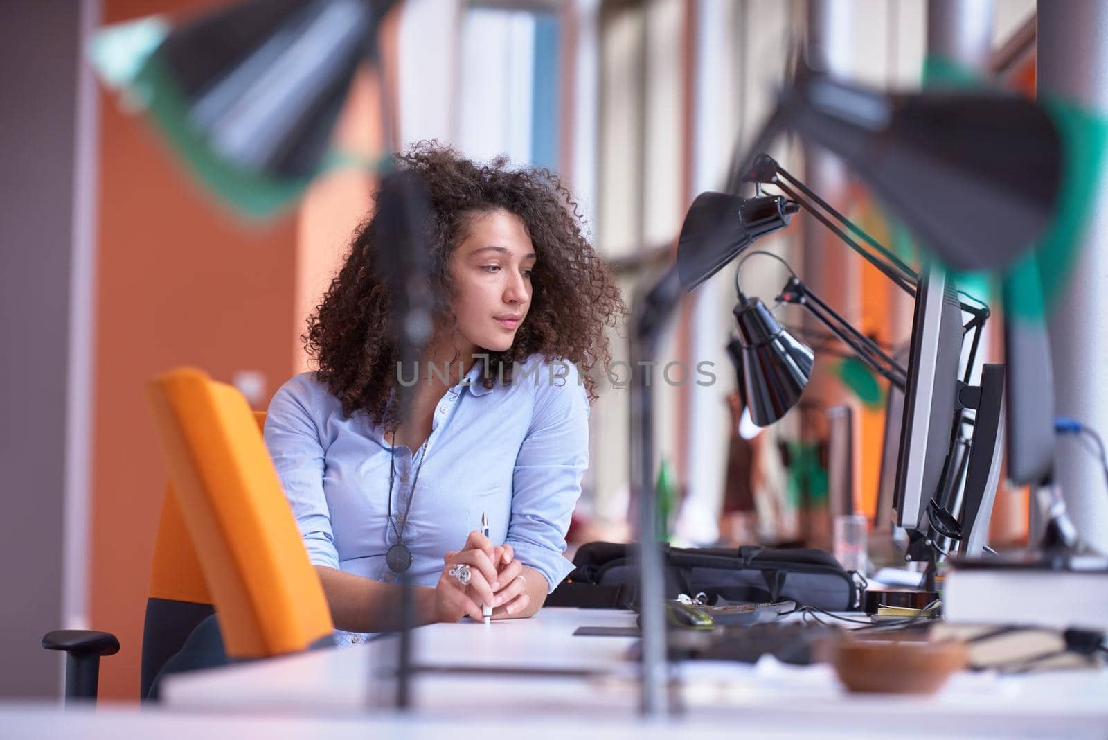 happy young  business woman with curly hairstyle in the modern office